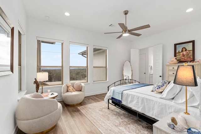 bedroom with ceiling fan and wood-type flooring