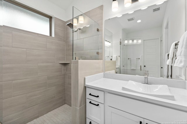 bathroom featuring vanity and a tile shower