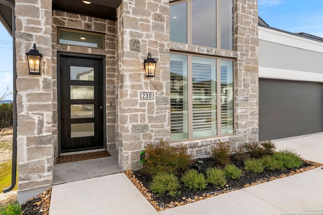 doorway to property with a garage