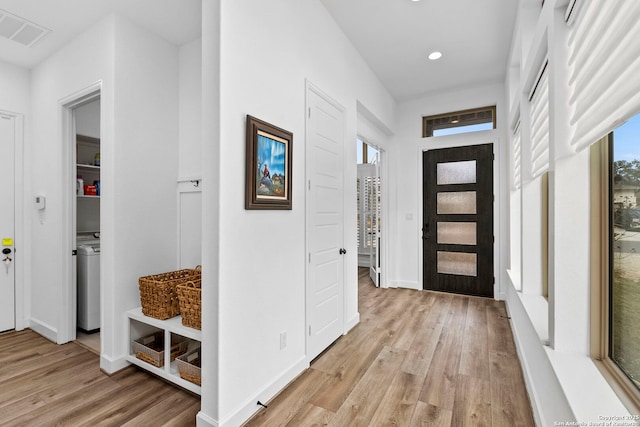 interior space featuring washer / clothes dryer and light hardwood / wood-style floors