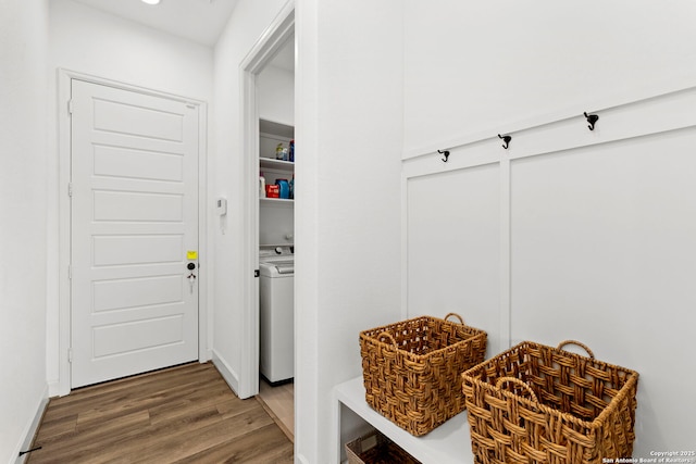 mudroom with wood-type flooring and washer / dryer