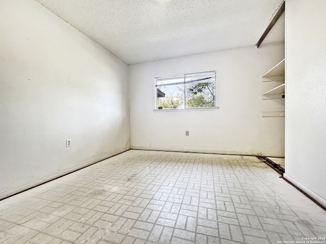 empty room with a textured ceiling