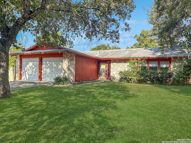 ranch-style home with a front yard and a garage