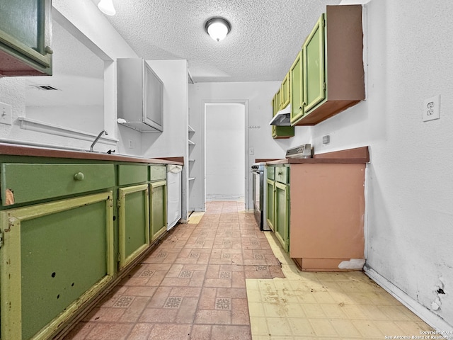 kitchen featuring range, a textured ceiling, and green cabinets