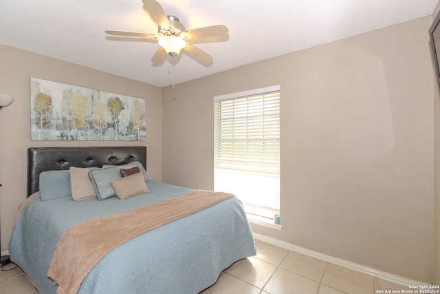 tiled bedroom featuring ceiling fan