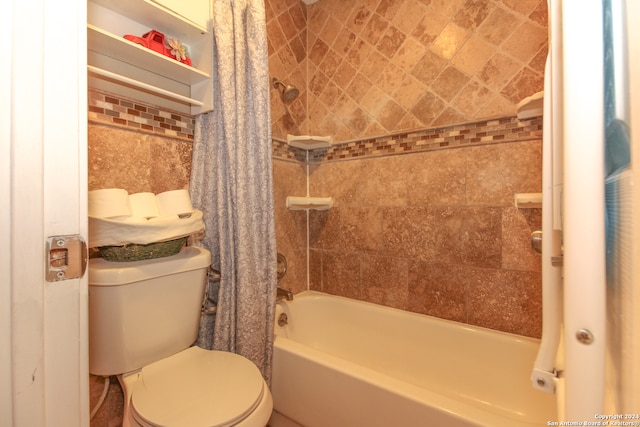 bathroom featuring shower / bath combo and toilet