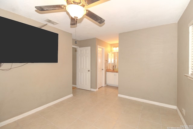 tiled spare room with ceiling fan