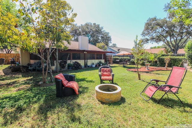 view of yard featuring an outdoor fire pit