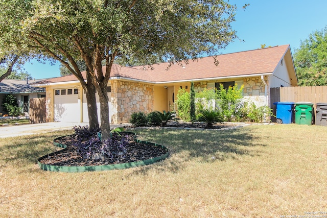 ranch-style house featuring a front yard and a garage