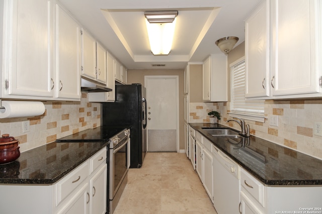 kitchen with a raised ceiling, white cabinetry, white dishwasher, stainless steel range with electric stovetop, and sink