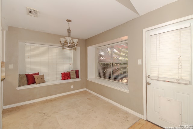 interior space featuring light hardwood / wood-style floors and a notable chandelier