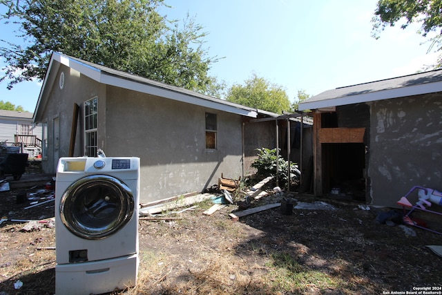 view of home's exterior with washer / clothes dryer