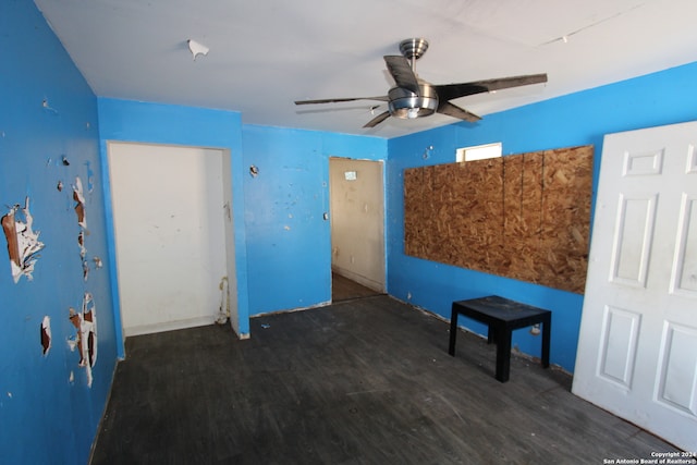 unfurnished living room with ceiling fan and dark hardwood / wood-style floors