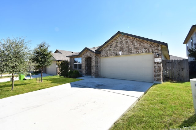 ranch-style house with a garage and a front lawn