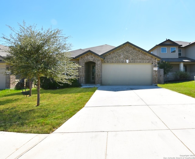 view of front facade with a front yard and a garage