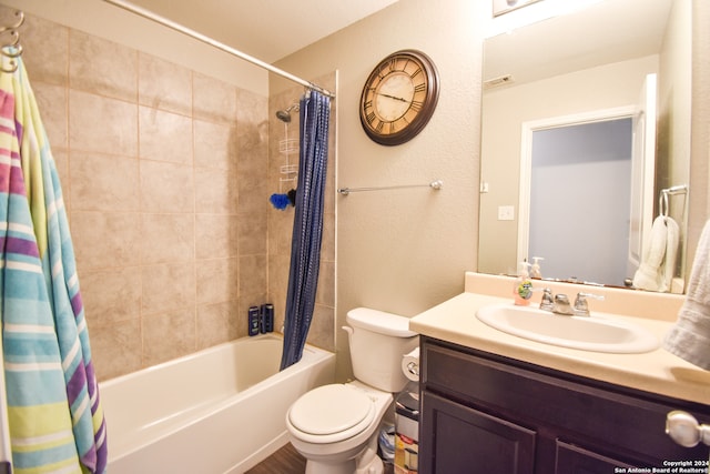 full bathroom featuring toilet, shower / bath combo, and vanity