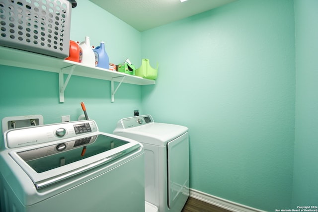 laundry room featuring washer and clothes dryer and dark hardwood / wood-style floors