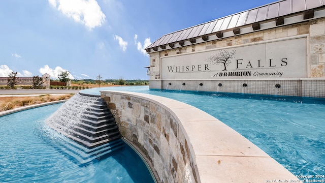 view of swimming pool featuring pool water feature