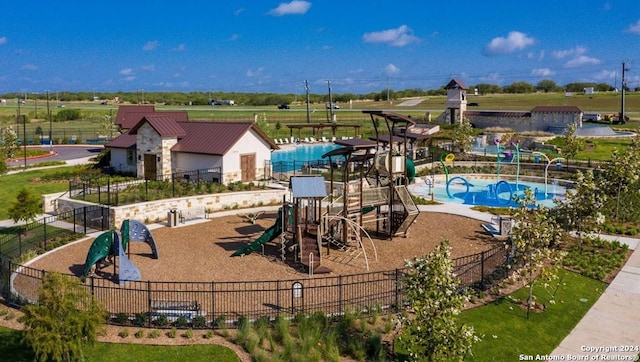 exterior space featuring pool water feature and a community pool