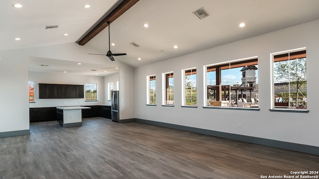 unfurnished living room with ceiling fan, vaulted ceiling with beams, and dark hardwood / wood-style flooring