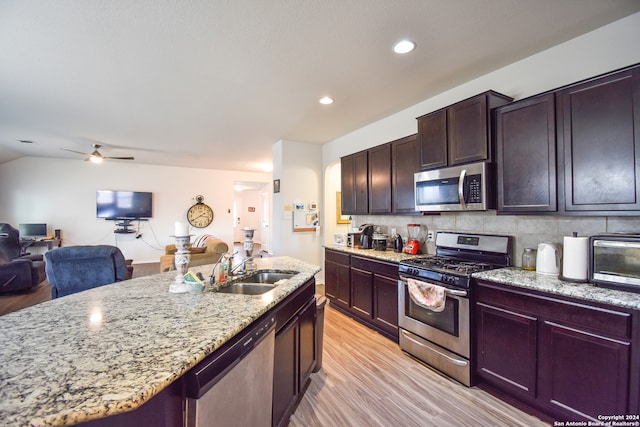 kitchen featuring decorative backsplash, ceiling fan, light hardwood / wood-style flooring, sink, and stainless steel appliances