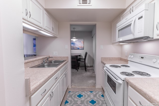 kitchen with white cabinets, sink, pendant lighting, light colored carpet, and white appliances