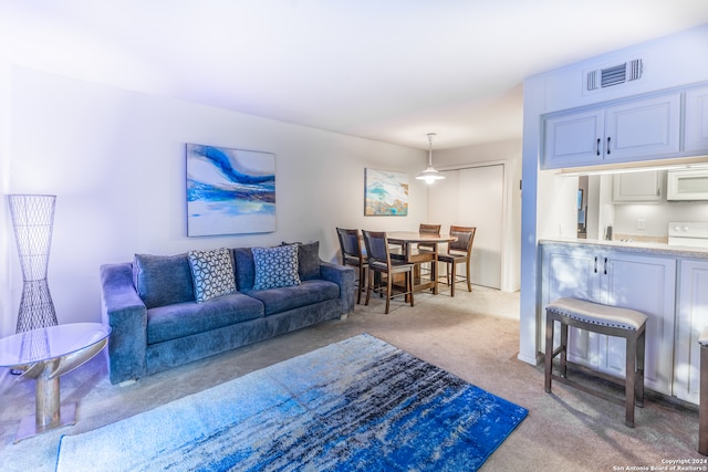 8702 Village Dr Unit 507, San Antonio, TX 78217 - living area with light colored carpet, visible vents, and indoor wet bar