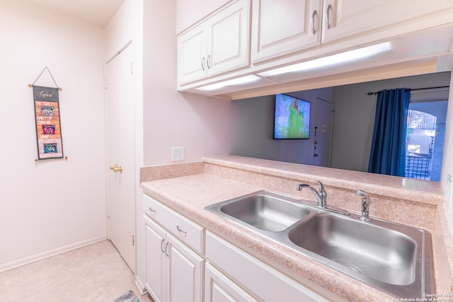 8702 Village Dr Unit 507, San Antonio, TX 78217 - kitchen featuring light countertops, white cabinetry, and a sink