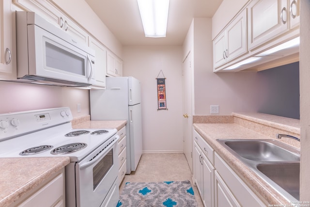 kitchen featuring white cabinets, sink, and white appliances