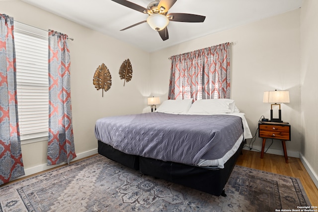 bedroom with ceiling fan and wood-type flooring