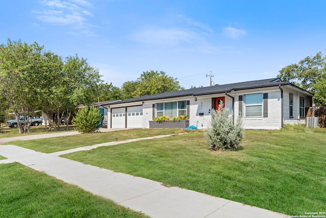 ranch-style house featuring a front yard and a garage