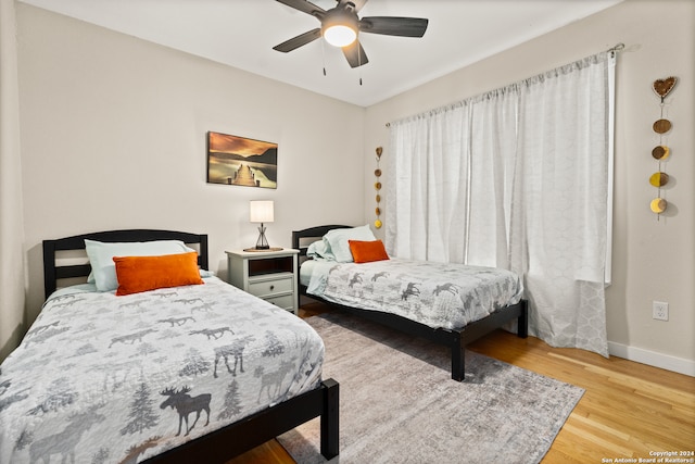 bedroom featuring light hardwood / wood-style floors and ceiling fan