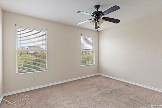 spare room with light carpet and ceiling fan