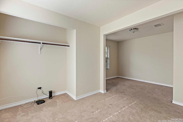 clothes washing area featuring light carpet