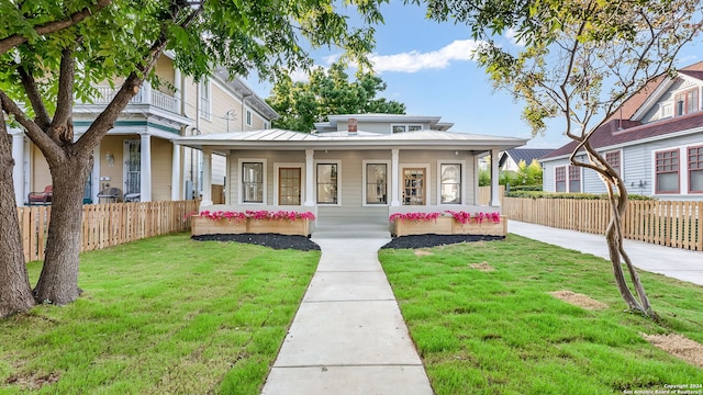 view of front of house with a porch and a front yard