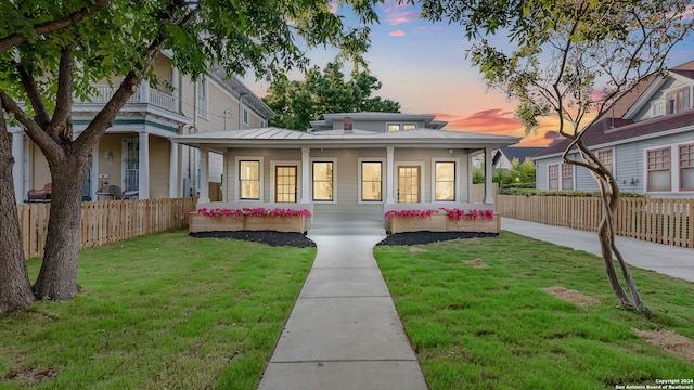 view of front of home featuring a yard and a porch