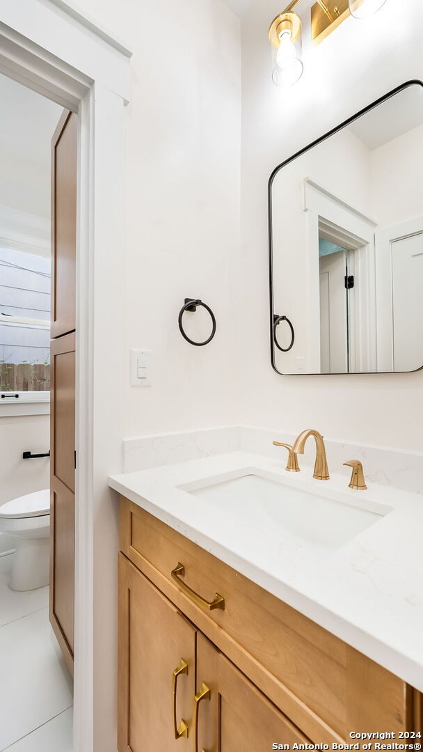 bathroom with vanity, toilet, and tile patterned floors