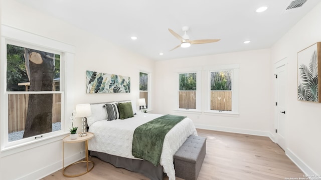 bedroom with light hardwood / wood-style floors and ceiling fan