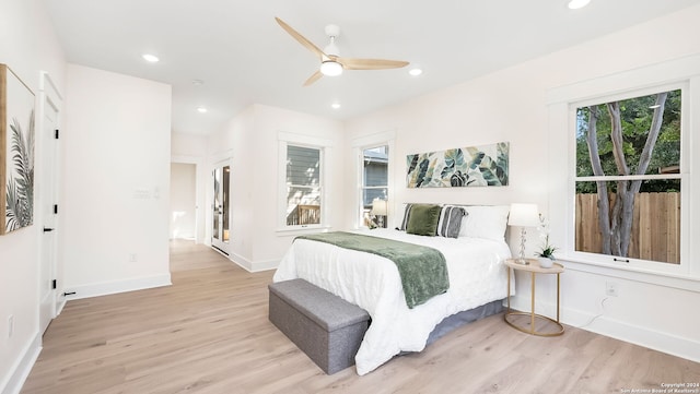 bedroom with light hardwood / wood-style floors and ceiling fan