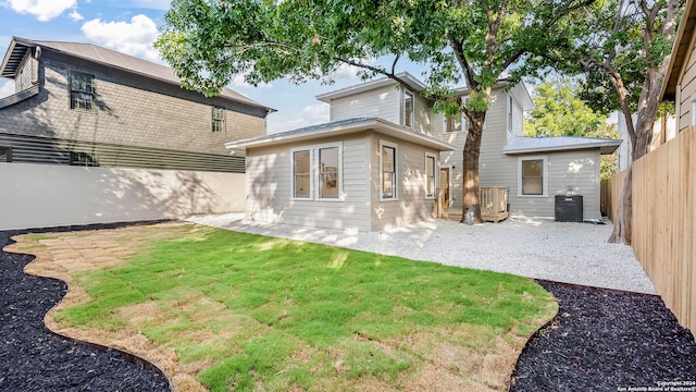 back of house featuring a patio and a lawn