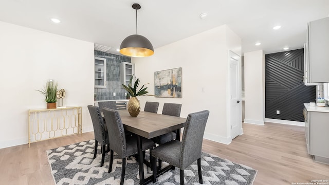 dining space with light hardwood / wood-style floors