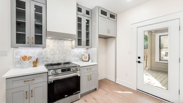 kitchen featuring light hardwood / wood-style flooring, stainless steel range, and gray cabinets