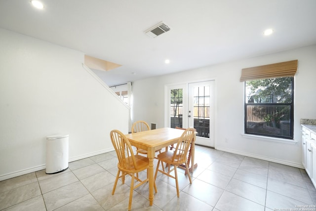 dining space featuring french doors and light tile patterned floors