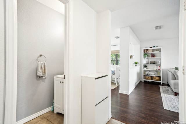 bathroom with hardwood / wood-style floors and built in features