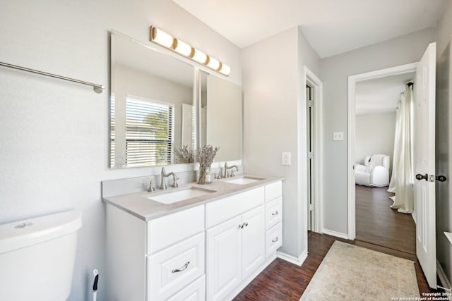 bathroom with vanity, hardwood / wood-style flooring, and toilet