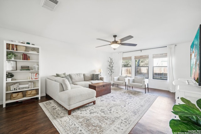 living room with dark hardwood / wood-style floors and ceiling fan