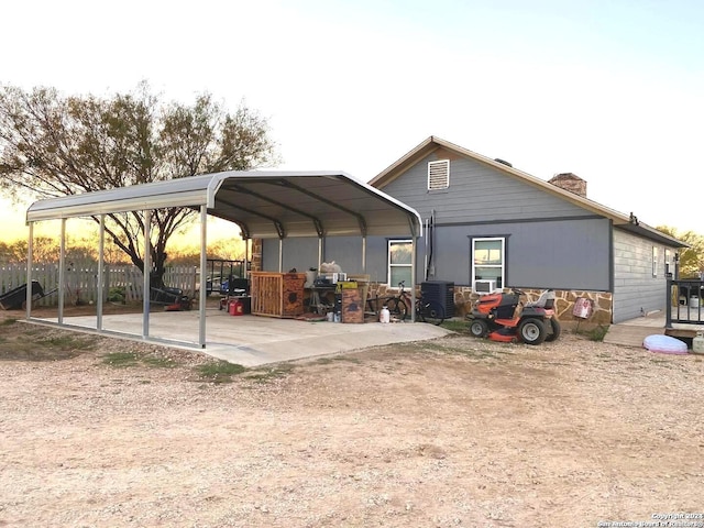 parking at dusk featuring a carport