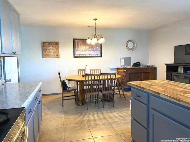 tiled dining area featuring a chandelier