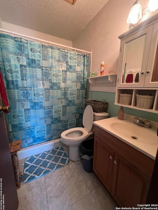 bathroom featuring a textured ceiling, toilet, vanity, tile patterned floors, and a shower with shower curtain