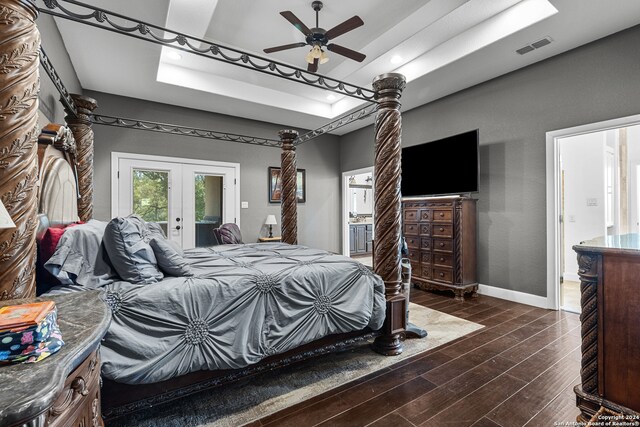 bedroom featuring ensuite bathroom, french doors, dark hardwood / wood-style flooring, access to exterior, and ceiling fan